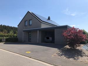 a house with a car garage with a driveway at B&Bagatelle in Malmedy