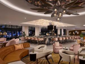 a hotel lobby with a bar and a restaurant at The Cottages at PGA National Resort in Palm Beach Gardens