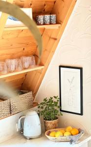 a kitchen with a shelf with a picture of a plant at Kleines Chalet im Erzgebirge mit Sauna und Kamin in Rechenberg-Bienenmühle