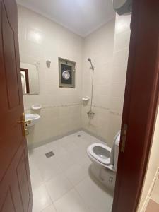 a bathroom with a toilet and a sink at قاردن وحدات سكنية خاصة in Al Madinah