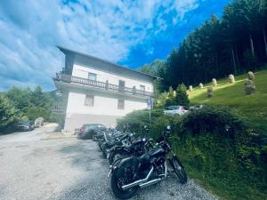 uma fila de motocicletas estacionadas em frente a um edifício em Alpenpension Gasthof em Ratten