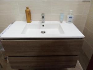 a white sink with two bottles on top of it at Etna Hiking House in Nicolosi