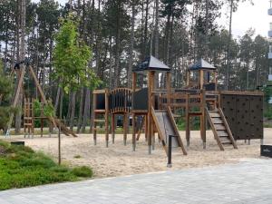 a park with a playground with a wooden play equipment at Rogowo 117J Shellter Apartments in Rogowo