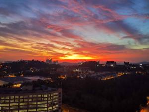 a sunset view of a city with a building at Enarahomes Shah Alam in Shah Alam