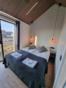 a bedroom with a bed with two towels on it at Arctic Exclusive Ranch in Kirkjubæjarklaustur