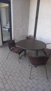 a table with four chairs around it in a building at the holiday house in Klaipėda