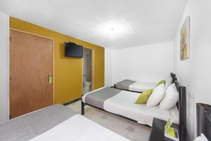 Postel nebo postele na pokoji v ubytování Hotel Casa Normandia