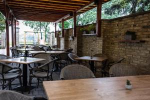 an empty restaurant with wooden tables and chairs at Vila Palić Soba 1 lux in Palić