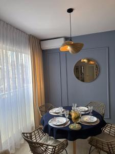 a dining room table with a blue table cloth and a mirror at PARAISO NACARADO GANDIA GRAU in Gandía
