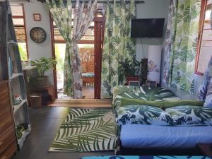 a living room with a couch and a tv at Tiki House in Bora Bora