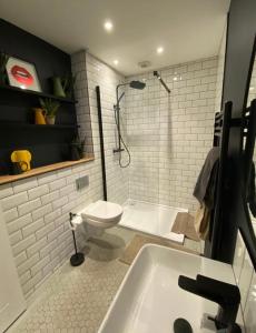a bathroom with a toilet and a shower and a sink at Studio 11 in Portstewart
