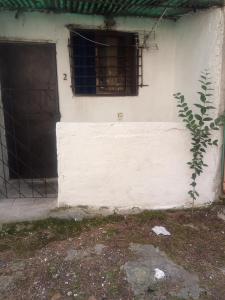 a white house with a window and a door at Private Studio 17 in Tirana