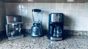 a blender sitting on a counter next to a coffee maker at San Angel Villas in San Antonio