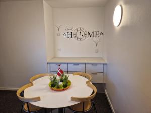 une cuisine avec une table blanche et deux chaises dans l'établissement Guest House Rens, à Bylderup-Bov