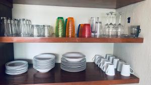 a shelf with plates and bowls and glass bottles at San Angel Villas in San Antonio