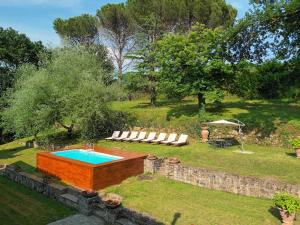 a swimming pool in the middle of a yard at Holiday Home Villa il Cesto in Greve in Chianti