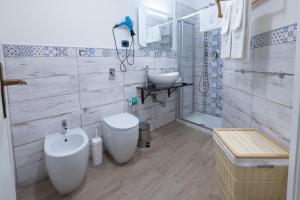 a bathroom with a toilet and a sink at Mori Carretti Tamburelli in Ispica