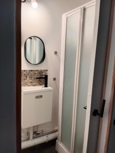 a bathroom with a mirror and a sink at Pounette, villa T2 RDC Thermes Centre Luxeuil in Luxeuil-les-Bains