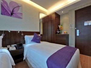Voodi või voodid majutusasutuse The Bauhinia Hotel - Tsim Sha Tsui toas