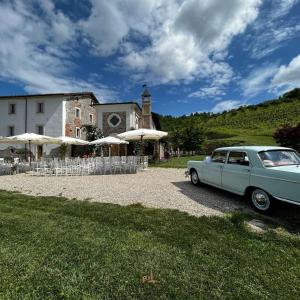 a blue car parked in front of a building at Tenuta Armonia in Clavesana
