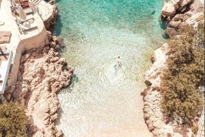 an aerial view of a beach with a person in the water at Ozy Apart / Can Andifli in Kaş