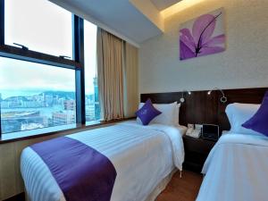 Voodi või voodid majutusasutuse The Bauhinia Hotel - Tsim Sha Tsui toas
