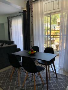 a table and chairs in a living room at Grey Nest Grey point 303 in Kericho