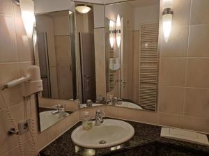 a bathroom with a sink and a large mirror at Ferienwohnung Wasserblick in Dewichow