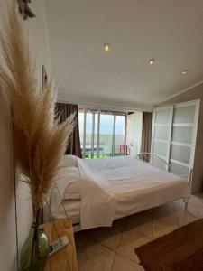 a bedroom with a large bed with white sheets at Studio apartment in Ivan Dolac