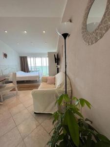 a living room with a couch and a mirror at Studio apartment in Ivan Dolac