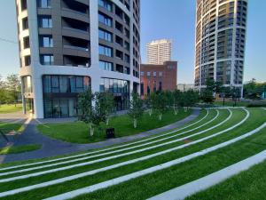 a park in front of a building with trees and buildings at Cozy 2 rooms flat - Castle view in Bratislava