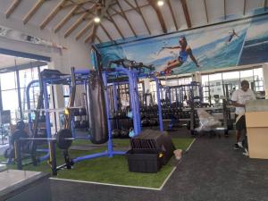 a gym with a large painting on the wall at Ballito Hills Lifestyle 1 Bed in Ballito
