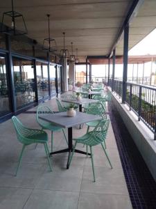 a group of tables and chairs on a balcony at Ballito Hills Lifestyle 1 Bed in Ballito