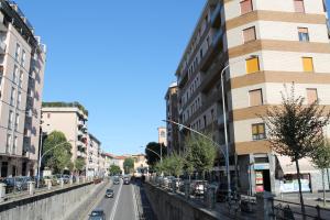 a city street with buildings and cars on the road at L'appartamento della Stazione di Saronno in Saronno