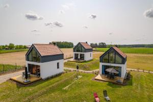 three small houses in a field with grass at Rybical 42 in Rybical