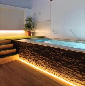 a swimming pool with a led lighting in a building at HELOHOME in Huétor Vega