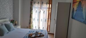 a bedroom with a bed with a window and a table at Aparhotel Mediterráneo by NeoHotels-Centro 8 min by Metro in Valencia