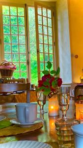 a dining room table with a vase of flowers and candles at Chateau Paysan ecolobio de Durianne in Le Monteil