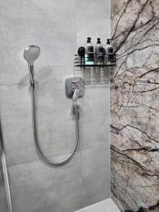 a shower with two bottles on a shelf in a bathroom at Apartament w Parku nad Kanałem in Bydgoszcz