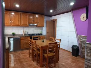 a kitchen with a wooden table and chairs in it at Casa da Bela Vista in Braga