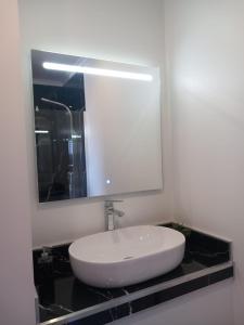 a bathroom with a white sink and a mirror at Casa da Bela Vista in Braga
