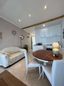 a living room with a table and a couch at Studio apartment in Ivan Dolac +12 photos