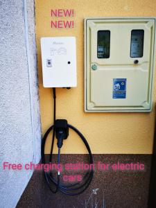a fire hose hooked up to a fire charging station for electric cars at Apartment and room Anica in Tolmin