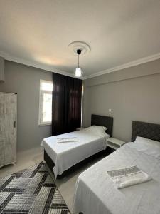 Postel nebo postele na pokoji v ubytování TAYCU APART d-2