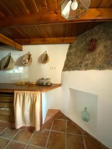 a room with a table and a stone wall at La Casita in Fuente del Oro
