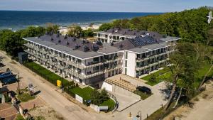 an aerial view of a large building next to the ocean at Apartament PLAŻOWY 214 - Rezydencja Niechorze in Niechorze