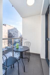 a balcony with a table and chairs and a window at Chłodna Apartment by Your Freedom in Warsaw