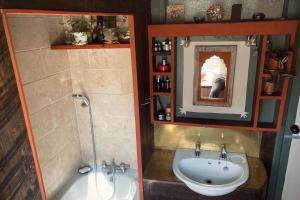 a bathroom with a sink and a tub and a mirror at Whichford Mill-large Cotswold Home in Shipston on Stour