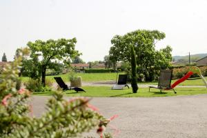 a group of chairs sitting in a park at Domaine des Marronniers in Tourtrol