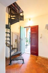 a spiral staircase in a room with a red door at B&B Mirella & Patrick in Boccea